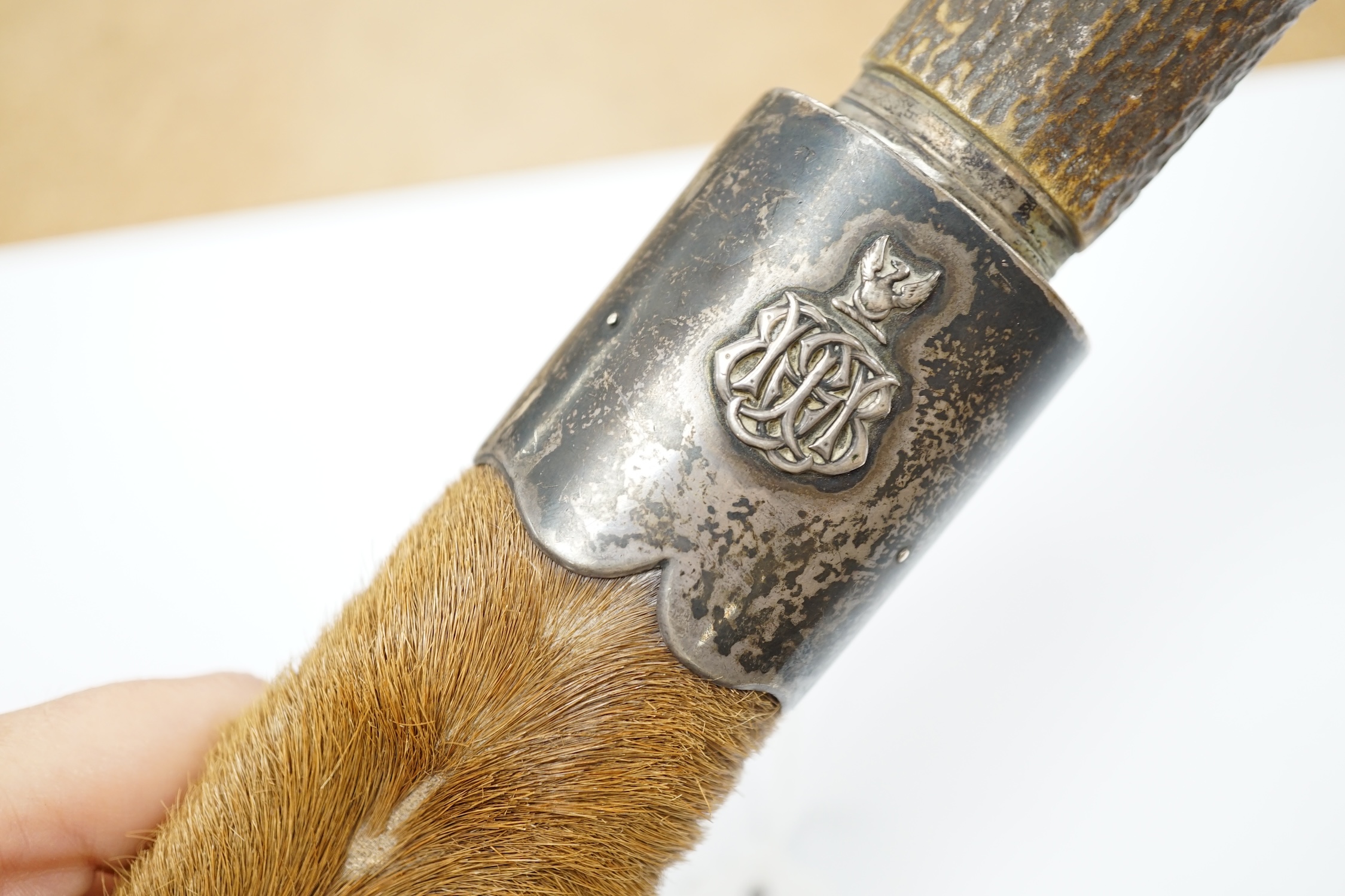 A Scottish dagger c.1900 with silvered mounts, including old initials engraved to pommel and applied to top mount, with deer skin covered sheath and antler grip, blade 19cm.